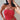 Woman wearing a red strapless top with a textured pattern against a neutral background