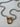 Close-up of chunky gold clasp on silver chain necklace showing mixed metals.