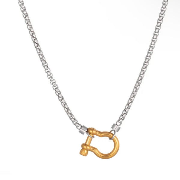 Gold and silver mixed metal chain necklace with bold gold clasp on white background